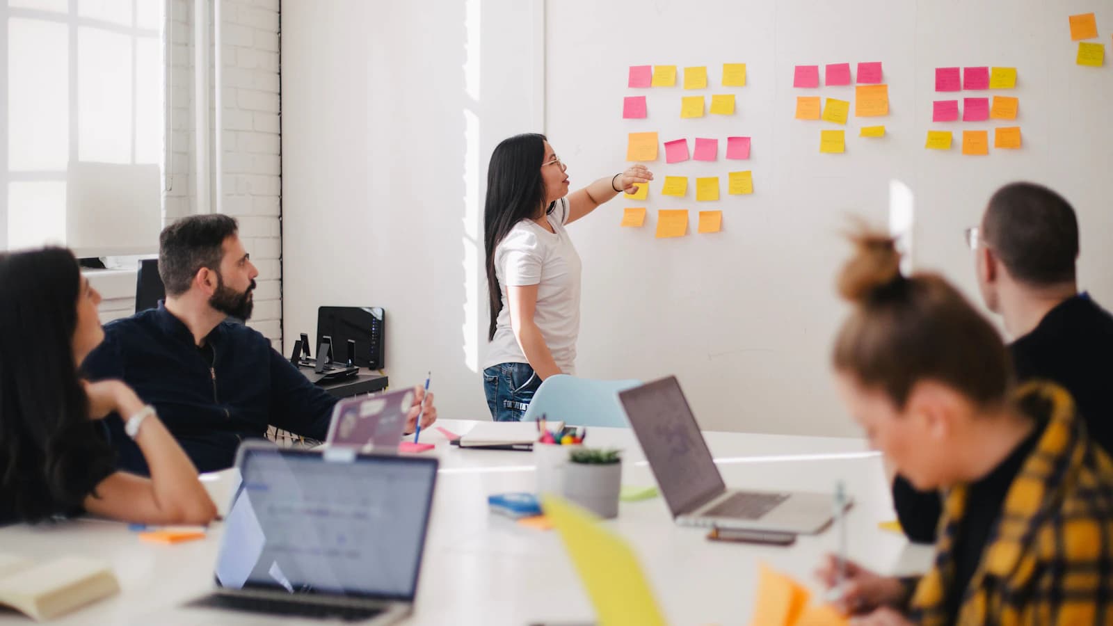 Business strategy meeting with AI implementation roadmap on screen